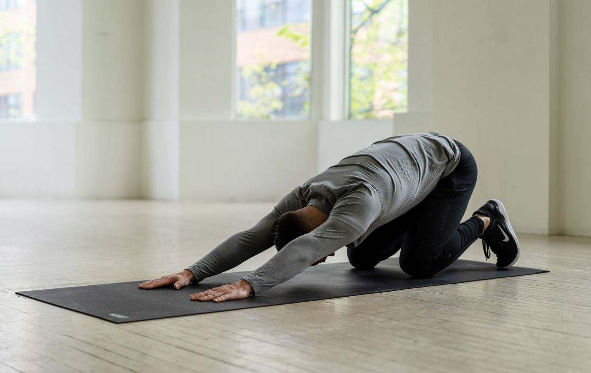 BT Health doing childs pose on a yoga mat